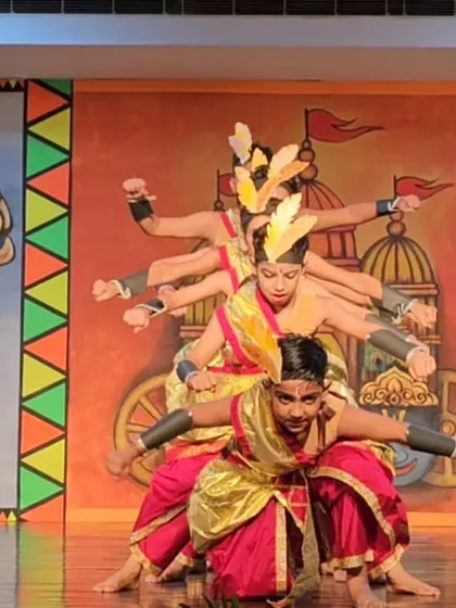 A creative formation by my students, depicting a multi-armed figure, similar to the professional troupe's performances.