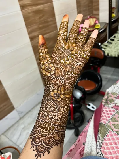 A full-hand design with intricate floral and paisley patterns.