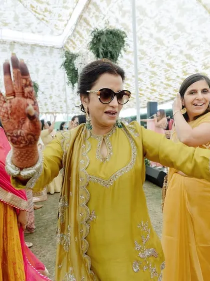 The energy at a Haldi is infectious. Here, guests are dancing and celebrating under elegant tents we designed with custom prints for an intimate day brunch.