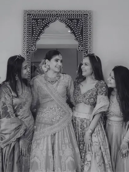 A classic black and white shot of the bride with her bridesmaids, capturing the friendship and joy of the bridal party.