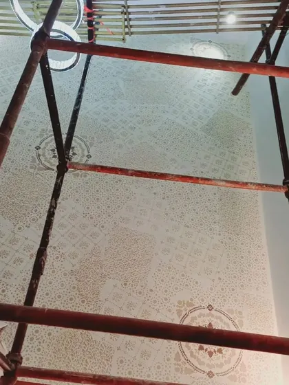 An upward view of the scaffolding and the ceiling during a decorative painting project. This demonstrates the scale of work we can undertake for large villas and independent houses with double-height areas.
