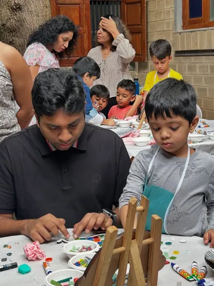 Another great shot of a father helping his son carefully place the mosaic tiles. These moments of collaboration are so special.