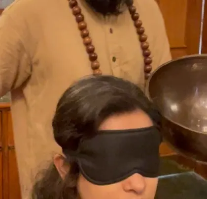 A close-up of a personal sound healing moment. Bringing the singing bowl near the head helps to balance the left and right hemispheres of the brain and quieten mental chatter.