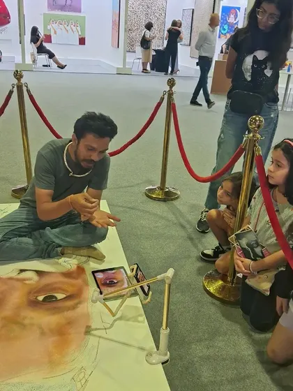 Artist Pramod Sahu engaging with young, aspiring artists at a live demonstration during World Art Dubai. We believe in inspiring the next generation and fostering a love for art from an early age.