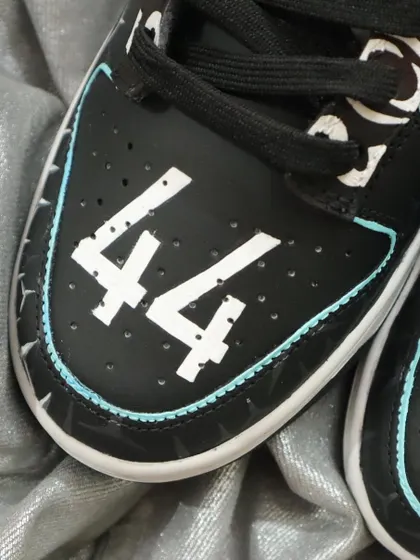 The final touch on the Mercedes F1 Dunks: Lewis Hamilton's iconic number 44 on the toe box. It's all about personalizing the design to celebrate your favorite driver and team.