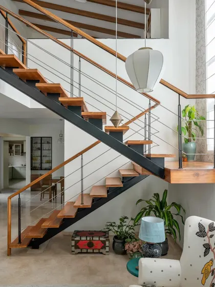 After: We clad the staircase in warm wood and added a matching railing, transforming it into a beautiful architectural feature that connects the floors.