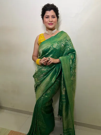 A confident pose on the red carpet. The entire look, from the saree draping to the makeup and hair, comes together perfectly for a glamorous event.