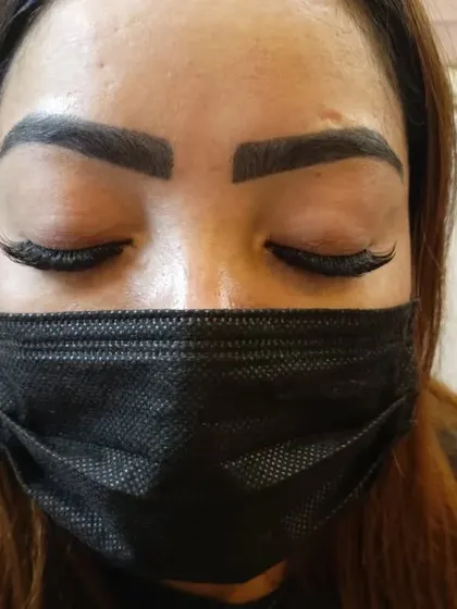 The same client with her eyes closed, showing the flawless application and texture of her wispy eyelash extensions. The lashes blend seamlessly for a natural yet enhanced look.
