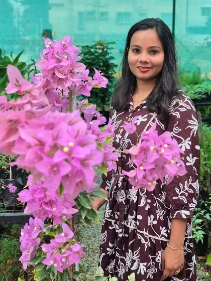 Posing with a beautiful pink bougainvillea. These moments, surrounded by the beauty we've helped create, are what make this entrepreneurial journey so rewarding.