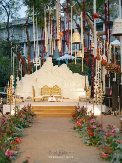 Inspired by the timeless love of Shiva and Parvati, this wedding stage featured a magnificent custom-carved backdrop. The aisle was lined with floral arrangements and traditional bells, creating a deeply spiritual and divine atmosphere.