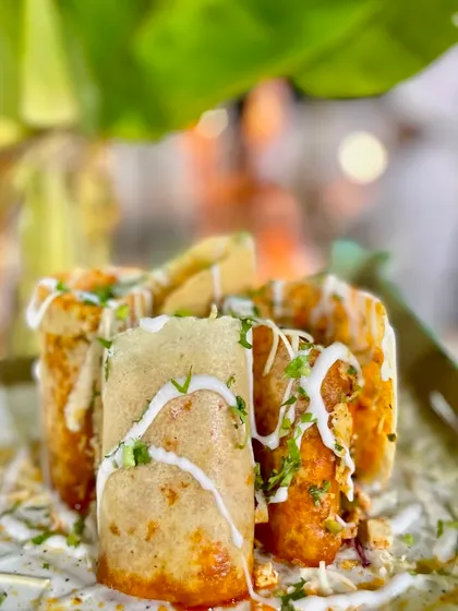 The Jini Dosa is a Mumbai street food favorite that I love to bring to my events. This crispy dosa is filled with a medley of vegetables and sauces, then rolled, cut, and served for a flavor-packed bite every time.