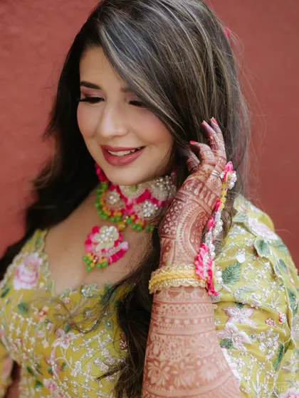 A close-up of the Mehndi makeup. You can see the details of her floral jewelry and the soft, pretty makeup that enhances her features.