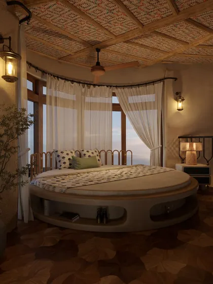 In this suite, a custom circular bed becomes the centerpiece, echoing the curved architecture of the room. Sheer curtains diffuse the natural light from the large windows, creating a soft, dreamy atmosphere perfect for a restful escape.