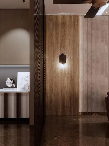 A view of the pantry and bar area connected to the home theatre. The design uses fluted panels and warm lighting to create a stylish and convenient space for snacks and drinks during a movie.