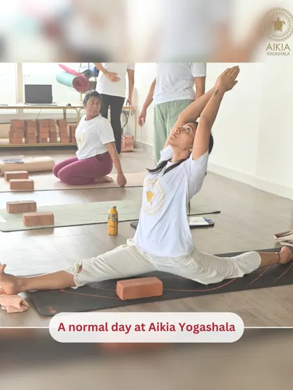 "A normal day at Aikia Yogashala." A student holds Hanumanasana (the splits) with ease, a testament to the flexibility and strength built through consistent practice.