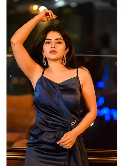 The versatility of this navy satin gown allows for dramatic and powerful poses, making the wearer feel confident and beautiful.