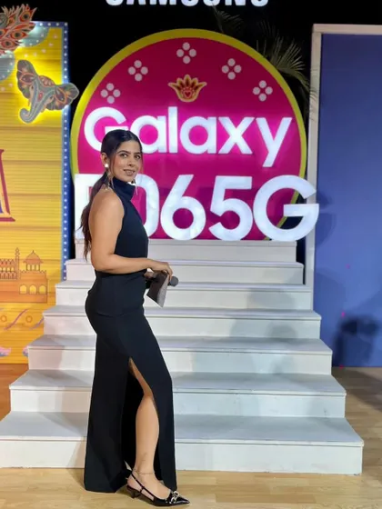 Posing at the Samsung Galaxy F06 5G launch event. The branding is vibrant and youthful, and my role was to match that energy on stage.
