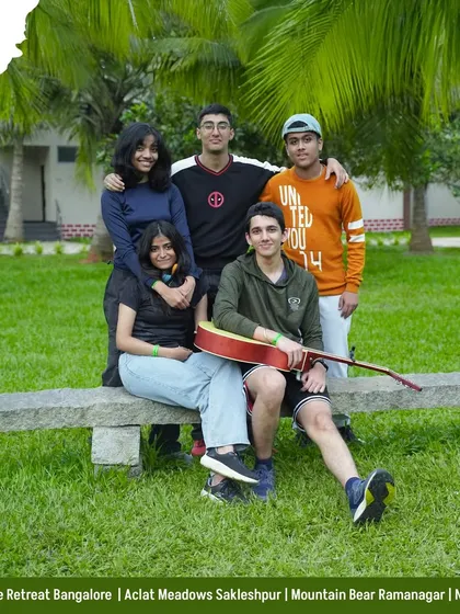Good vibes and good company. A group of friends relaxes with a guitar on our lawns, enjoying a peaceful moment between adventures.