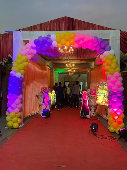 The entrance to the Disney Princess party, featuring a red carpet and a colorful balloon arch to welcome the guests.