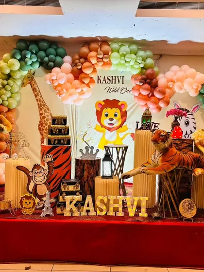 We can customize our jungle theme to fit your vision. This setup for Kashvi's "Wild One" party includes a mix of cartoon and plush animals, creating a playful and inviting atmosphere on stage.