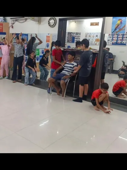 Students participating in a physical theatre exercise. These activities help them understand how to use their bodies to tell stories and express emotions, a key component of our drama curriculum.