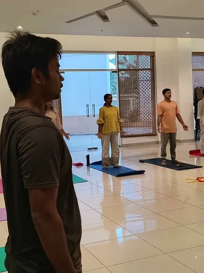 Participants in a healing workshop with live flute music, standing in a receptive posture to absorb the calming sounds.