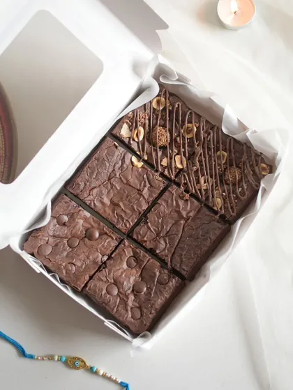 Another look at the assorted brownies, with a Rakhi placed beside the box to celebrate the occasion.