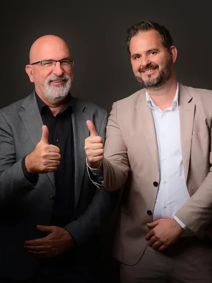 A positive and confident shot of two business leaders giving a thumbs-up. This kind of image is perfect for internal communications or celebrating a company milestone.