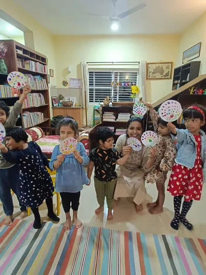 A slightly different angle of the proud children and their dot painting crafts.
