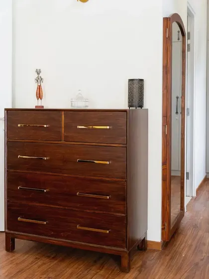 A duplicate of image 192, highlighting the sleek chest of drawers and the practical swing-out mirror.