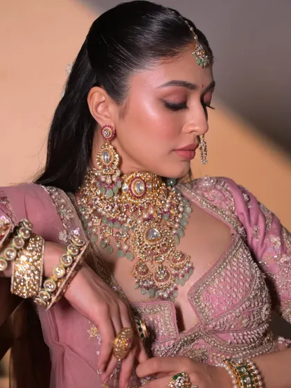 A serene and elegant portrait. The soft pink tones and glowing skin create a look of timeless beauty.
