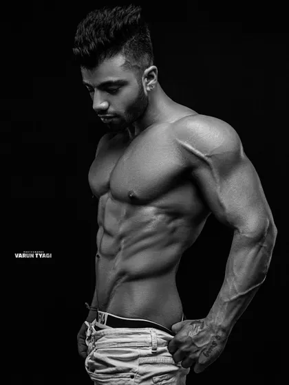 A black and white photo highlighting the lines and symmetry of my physique. Classic posing for a classic look.
