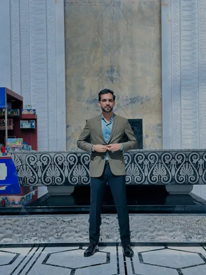 A full-length shot showing my business casual attire. I pay attention to detail, from the fit of the jacket to the shine of my shoes, because presentation matters.