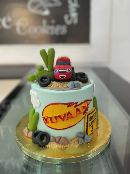 Here's a fun cake based on the popular show Blaze and the Monster Machines. We used fondant to create the character and desert-themed elements like cacti and tires.