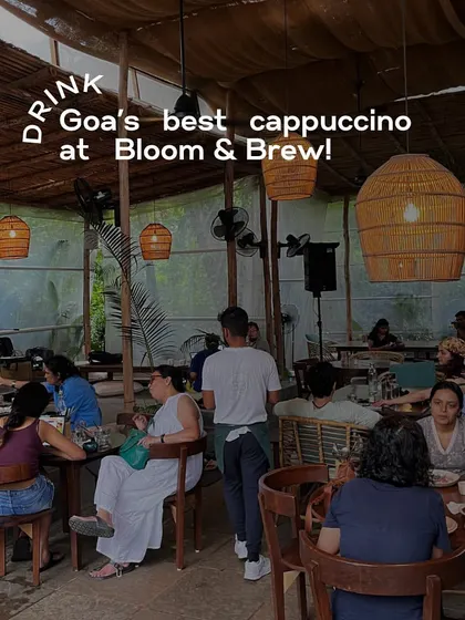 An atmospheric shot of the interior of Bloom & Brew, Goa. This image captures the buzzing, rustic vibe of the cafe, inviting people to visit.