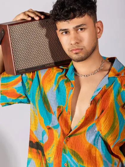 A vibrant, tropical-themed shoot for a men's summer collection. I paired a colorful printed shirt with white shorts and casual accessories like headphones and a speaker to create a fun, youthful, and energetic vibe.