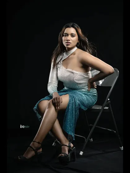 This dual-toned sequin dress shifts from off-white to blue and features a single sleeve and a choker neck design. It's a unique and edgy party wear option.