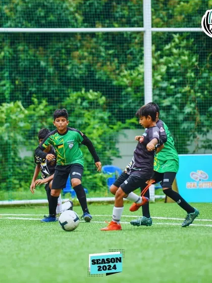 Players swarm the ball in a competitive moment from the MDL Tournament.