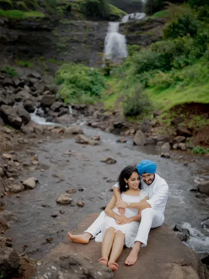 The couple sharing a quiet moment by the water, showcasing the tranquility and romance of an outdoor pre-wedding session.
