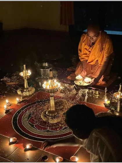 Another perspective of the puja ceremony, showing the intricate mandala and the arrangement of lamps. Every element of the ritual has a deep symbolic meaning.