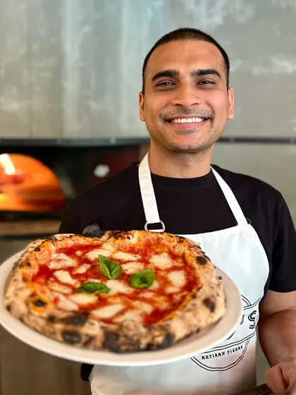 Our pizzaiolo Amol, looking happy to serve you the best pizza in town.