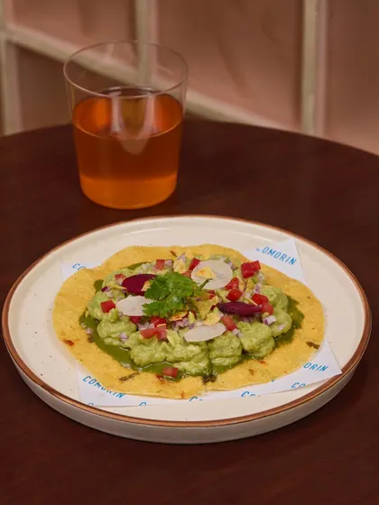 Avocado toast, the Comorin way. I layer nimbu-masala spiked avocado on a crisp Banarasi aloo papad and top it with radish, onions, and chillies.