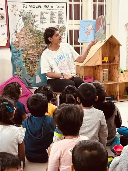 A quiet moment of shared reading. In our unhurried environment, there is always time to gather for a story, fostering a sense of community and a love for books.