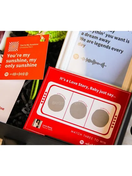 A detailed shot of the interactive Spotify scratch card from the 'Tunes of Love' hamper.