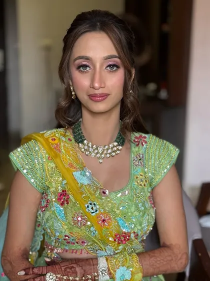A beautiful portrait of the bride on her Haldi day, with her hair styled in a soft, romantic half-updo.