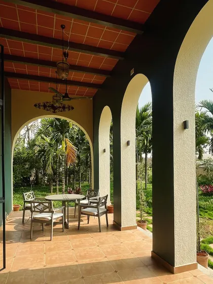 Another shot of the long, arched veranda, showcasing its role as a transitional space between the interior and the lush exterior.