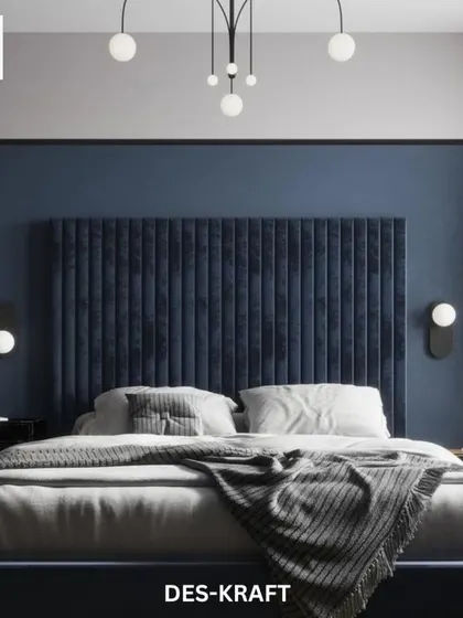 A striking deep blue velvet fluted headboard serves as the dramatic focal point in this modern bedroom, complemented by minimalist globe sconces and a sculptural chandelier.