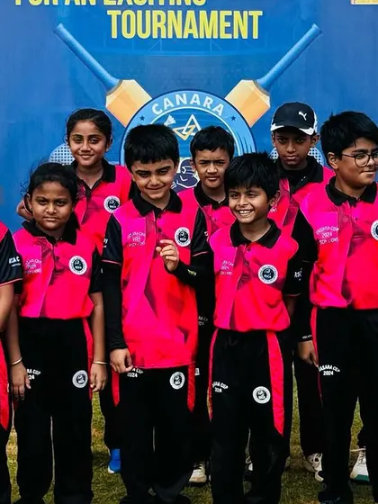 The U-10 team in their bright pink jerseys, ready for their match.