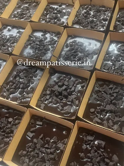 A batch of our chocolate brownies, topped with chocolate chips, ready to be baked for a bulk corporate order.