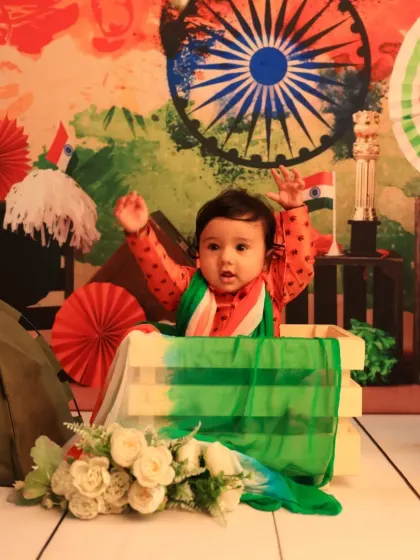 Hands up for India! A joyful and energetic shot from our Independence Day themed mini-session, capturing a baby's excitement.